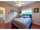 Comfortable bedroom offers a window, closet, ceiling fan and hardwood floors at 18518 Bittern Ave, Lutz, FL 33558