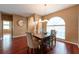 Stylish dining room featuring hardwood floors, pendant lighting, and large arched windows at 18518 Bittern Ave, Lutz, FL 33558