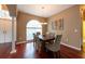 Elegant dining room with a modern chandelier, large windows, and hardwood floors at 18518 Bittern Ave, Lutz, FL 33558