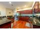 Well-appointed kitchen featuring granite counters, stainless steel appliances, and wood cabinets at 18518 Bittern Ave, Lutz, FL 33558