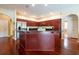 Bright kitchen with cherry wood cabinets, stainless appliances, granite counters and wood floors at 18518 Bittern Ave, Lutz, FL 33558