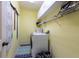 Functional laundry room with a white washer and dryer, shelving, and a striped rug on the floor at 18518 Bittern Ave, Lutz, FL 33558