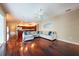 Open living room with kitchen view, hardwood floors and comfortable seating at 18518 Bittern Ave, Lutz, FL 33558