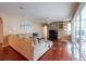 Large living room with wood floors, neutral colors, and sliding glass doors to lanai at 18518 Bittern Ave, Lutz, FL 33558