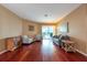 Spacious living room featuring hardwood floors, comfortable seating, and sliding glass doors at 18518 Bittern Ave, Lutz, FL 33558