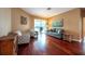 Well-lit living room showcasing hardwood floors, cozy armchairs, and access to the patio at 18518 Bittern Ave, Lutz, FL 33558