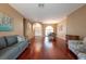 Bright and airy living room with beautiful hardwood floors and comfortable seating arrangements at 18518 Bittern Ave, Lutz, FL 33558