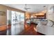 Bright living room boasts hardwood floors, a large sliding glass door to the outside, and an open floor plan at 18518 Bittern Ave, Lutz, FL 33558