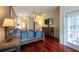 Spacious main bedroom with hardwood floors, ceiling fan, and access to bathroom and outside area at 18518 Bittern Ave, Lutz, FL 33558