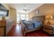 Spacious main bedroom with natural light, hardwood floors, ceiling fan, and wood furniture at 18518 Bittern Ave, Lutz, FL 33558