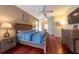 Spacious main bedroom with hardwood floors, ceiling fan, and TV at 18518 Bittern Ave, Lutz, FL 33558