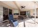 Enjoy the covered patio with a dining area and comfortable lounge chair, perfect for relaxing outdoors at 18518 Bittern Ave, Lutz, FL 33558