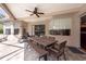 Relax on this covered patio with a dining area and outdoor seating, perfect for enjoying the backyard view at 18518 Bittern Ave, Lutz, FL 33558