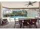Enjoy the outdoors on this screened patio, featuring an outdoor dining set and a view of the pool at 18518 Bittern Ave, Lutz, FL 33558