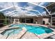 Relax in the screened-in pool and spa, surrounded by a spacious brick paver deck, creating a backyard paradise at 18518 Bittern Ave, Lutz, FL 33558