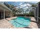 Cool off in this inviting screened-in pool and spa combo surrounded by brick pavers perfect for relaxing by the pool at 18518 Bittern Ave, Lutz, FL 33558