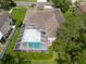 Aerial view of the home's large screened-in pool and patio with seating, creating a relaxing outdoor space at 18518 Bittern Ave, Lutz, FL 33558