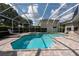 Enjoy the screened-in pool with a built-in spa, perfect for relaxation and entertainment in your private backyard at 18518 Bittern Ave, Lutz, FL 33558