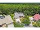 Overhead shot showcases a luxury house with professional landscaping, a driveway, and an immaculate lawn at 1877 Muirfield Way, Oldsmar, FL 34677