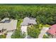 A high angle, aerial shot showcasing a house with impeccable landscaping, a driveway, and a pristine lawn at 1877 Muirfield Way, Oldsmar, FL 34677