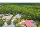 Lush surroundings envelop an estate home with a private pool, driveway, and beautiful landscaping at 1877 Muirfield Way, Oldsmar, FL 34677