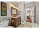 Cozy bathroom features a decorative mirror, traditional vanity and stylish tile flooring at 1877 Muirfield Way, Oldsmar, FL 34677