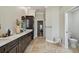 Stylish bathroom with a double vanity, marble countertop, dark wood cabinets and tile flooring at 1877 Muirfield Way, Oldsmar, FL 34677