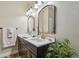 Stylish bathroom with double vanity, elegant mirrors, and decorative plant for a fresh touch at 1877 Muirfield Way, Oldsmar, FL 34677