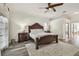Bedroom showcasing decorative bed frame, ample natural light, and wood-look floors at 1877 Muirfield Way, Oldsmar, FL 34677