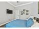 Well-lit bedroom boasts hardwood floors, ceiling fan, and modern entertainment setup at 1877 Muirfield Way, Oldsmar, FL 34677