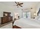 Bedroom with a TV, French doors, and a ceiling fan for additional comfort and air circulation at 1877 Muirfield Way, Oldsmar, FL 34677