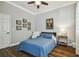 Tranquil bedroom with hardwood flooring, a side table lamp, and a decorative bed at 1877 Muirfield Way, Oldsmar, FL 34677