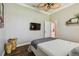 Bedroom featuring modern decor, ceiling fan, television, and a view into the bathroom at 1877 Muirfield Way, Oldsmar, FL 34677