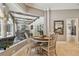 Breakfast nook with large windows overlooking a backyard, with a kitchen and living area in view at 1877 Muirfield Way, Oldsmar, FL 34677