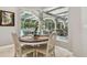 Cozy breakfast nook with seating for four, offering views of the outdoor pool and screened patio area at 1877 Muirfield Way, Oldsmar, FL 34677