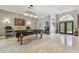 Grand foyer with travertine floors leading to the game room and home office at 1877 Muirfield Way, Oldsmar, FL 34677