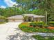 Inviting home exterior boasts a three-car garage and a well-manicured lawn at 1877 Muirfield Way, Oldsmar, FL 34677