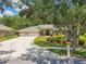 Inviting home exterior boasts a three-car garage and a well-manicured lawn at 1877 Muirfield Way, Oldsmar, FL 34677