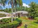 Charming home exterior with landscaped yard, and spacious driveway at 1877 Muirfield Way, Oldsmar, FL 34677