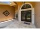 Inviting front porch with tiled flooring and decorative double doors at 1877 Muirfield Way, Oldsmar, FL 34677