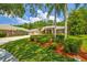 Beautiful single-story home with a well-manicured lawn and mature trees at 1877 Muirfield Way, Oldsmar, FL 34677