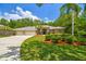 Well-maintained home featuring manicured landscaping, a lush lawn, and a three-car garage at 1877 Muirfield Way, Oldsmar, FL 34677