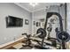Home gym featuring weightlifting equipment and a mirrored closet, ideal for staying in shape at 1877 Muirfield Way, Oldsmar, FL 34677
