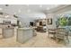Spacious open-concept kitchen with granite countertops, center island, and adjacent dining area at 1877 Muirfield Way, Oldsmar, FL 34677