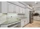 Modern kitchen with granite counters, tiled backsplash, and stainless steel appliances at 1877 Muirfield Way, Oldsmar, FL 34677