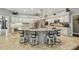 Kitchen island with granite countertops and seating for four at 1877 Muirfield Way, Oldsmar, FL 34677