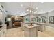 Open-concept kitchen featuring granite countertops, stainless steel appliances, and natural light at 1877 Muirfield Way, Oldsmar, FL 34677