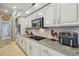 Modern kitchen with granite countertops, and stainless steel appliances at 1877 Muirfield Way, Oldsmar, FL 34677