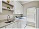 Bright laundry room featuring ample counter space and modern appliances for convenient chores at 1877 Muirfield Way, Oldsmar, FL 34677