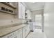 Well-lit laundry room featuring modern white cabinets, granite countertops, and new washer/dryer at 1877 Muirfield Way, Oldsmar, FL 34677